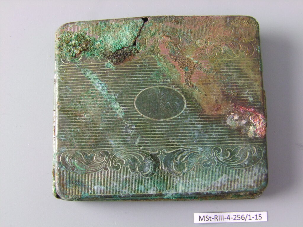 Cigarette case, property confiscated from prisoners. Condition before conservation.