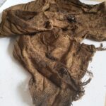 A scarf belonging to one of the execution victims. Condition before conservation.