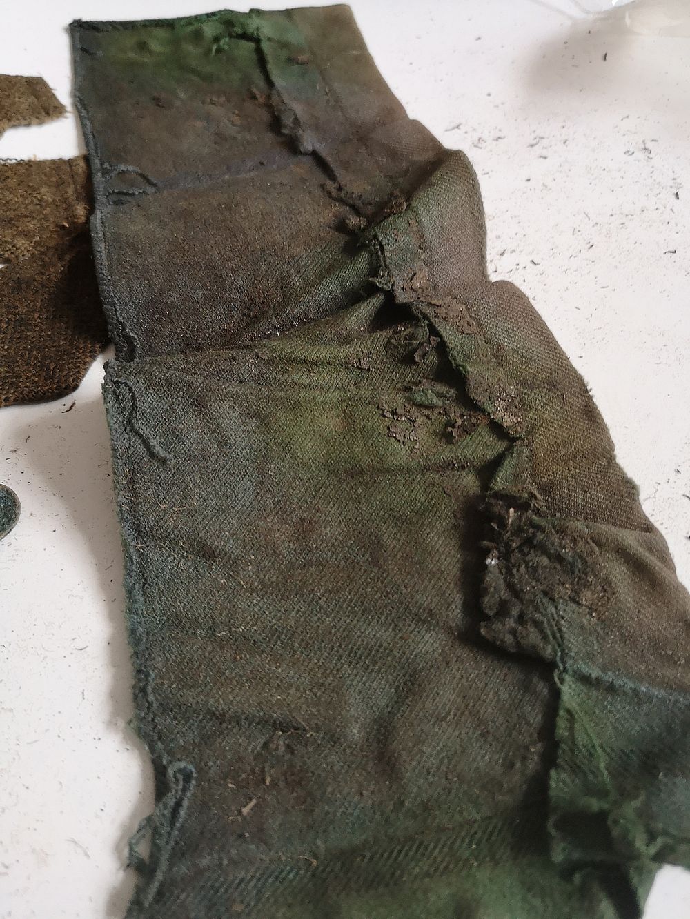 A fragment of a jacket belonging to one of the victims of the execution. Condition before conservation.